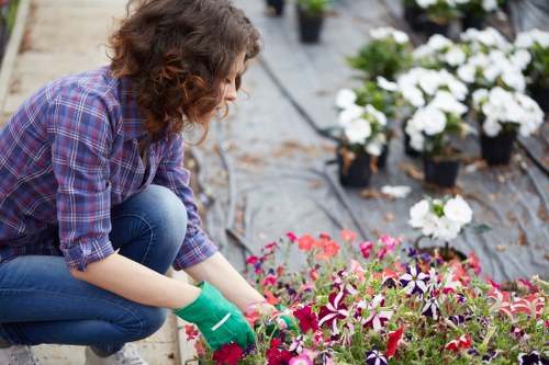 A gardener using protective equipment during routine maintenance
