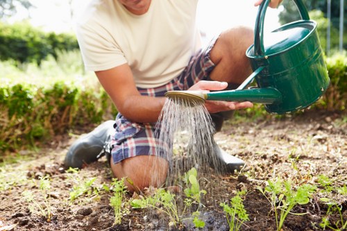 Welling gardeners using protective equipment during maintenance work